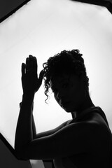 Dark-skinned young woman on a white background. Closeup portrait of African American girl.