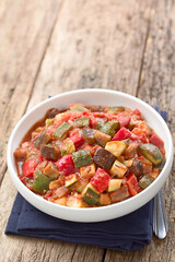 Fresh Ratatouille, a traditional French vegan vegetable stew made of eggplant, zucchini, bell pepper, tomato and onion with herbs (Selective Focus, Focus in the middle of the dish)