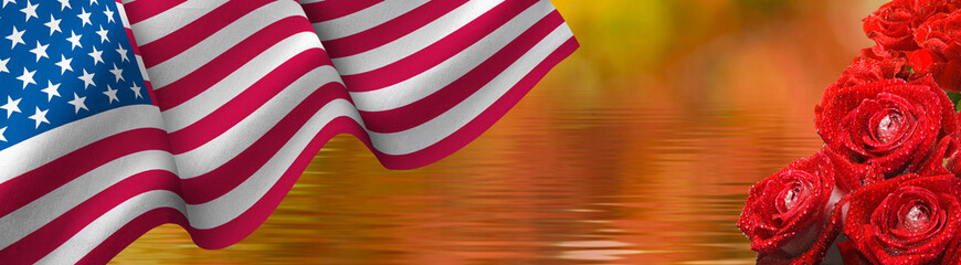  flag of the United States of America waving in the wind and beautiful holiday flowers