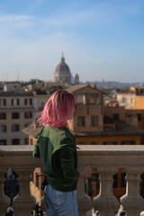 A young woman with pink hair, a tourist in Rome.