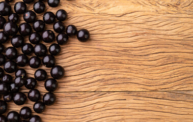 Jabuticabas over wooden table with copy space