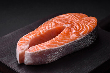 Fresh raw red fish steak with spices and herbs