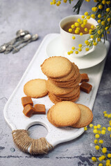 Palets bretons, french cookies. Salted caramel Shortbread Breton cookies, cup of coffee and mimosa