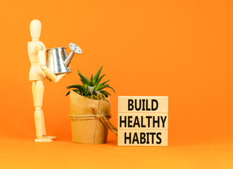 Motivation and Build healthy habits symbol. Concept words Build healthy habits on wooden block on a...