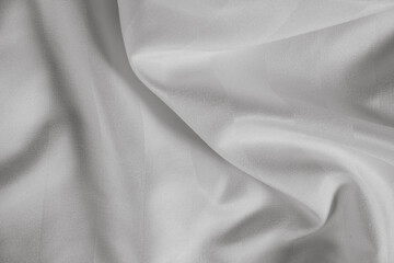 Light grey abstract background, satin texture, wavy fabric folds