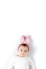 Baby with rabbit ears on a white background. Concept blank for Easter. Mockup for advertising, design, celebration, postcards. Copy space.