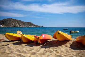 View of yellow canoes at the sandy Mylopotas Beach in Ios Greece 