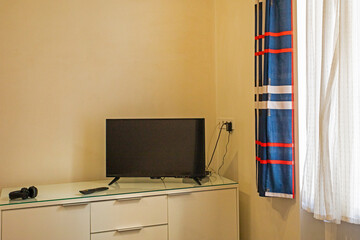 modern stylish cozy interior near the window with TV.Cabinet