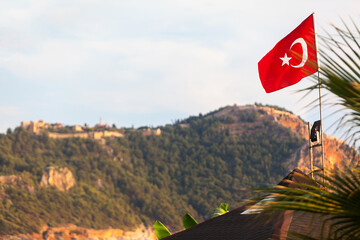 Turkish flag on the background of a mountain cliff. The Alanya, Turkey