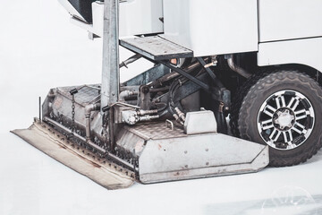 Hockey rink ice filling machine. Rear part of ice resurfacer machine while ice polishing process