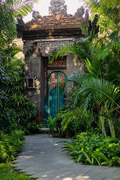 balinese garden with door in sunset light 