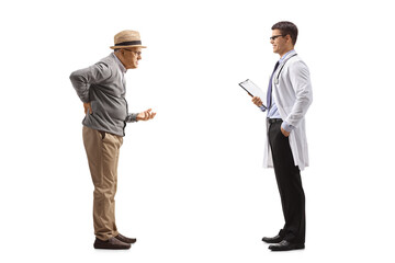 Full length profile shot of a senior man with a back pain talking to a doctor