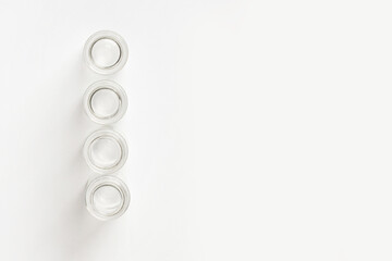 set of empty small glass jars on a light background. View from above.
