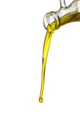 Organic olive oil pouring from carafe  into glass bowl