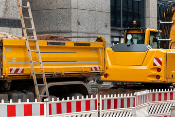 Sity street renovation rebuilding construction site with dump truck flasher excavator digging earth...