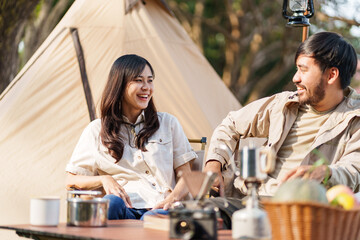 Asian couple camping outdoors. Couple travelers holding hands together love and Travel Lifestyle.