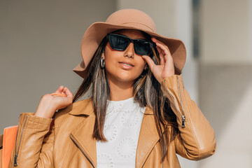 brunette latina girl on the street with shopping and shopping bags