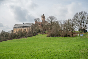 Fototapeta na wymiar Ronneburg Castle during cloudy day with meadow in front, Germany