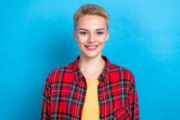 Photo portrait of young positive lady short blonde hairstyle smiling wear red checkered shirt enjoy her lifestyle isolated on blue color background