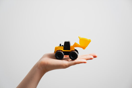 Female handle holding earthmoving equipment construction small plastic toy wheel loader