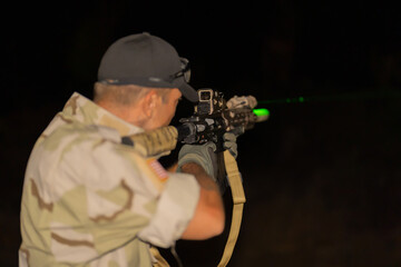 Team of U.S. Army marine corps soldier military war at night mission with gun participating and preparing to attack the enemy in Thailand during Exercise Cobra Gold in battle. Combat force training.