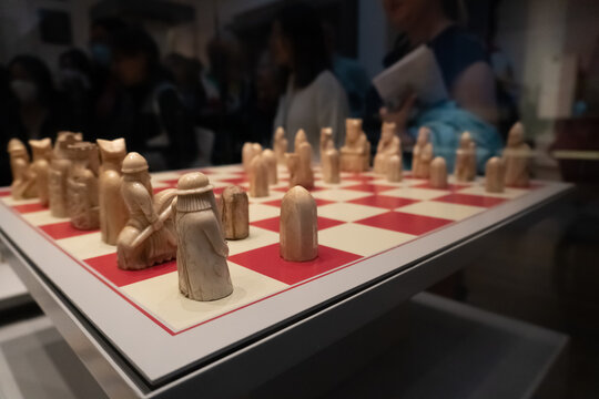 The British Museum display of The Lewis chessmen, group of distinctive 12th-century chess pieces, along with other game pieces, most of which are carved from walrus ivory.