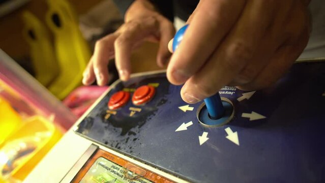 Angry man play on joystick of a vintage arcade videogame - Coin-Operated