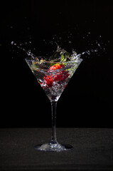 
Freezing the action. Strawberry falling into the water