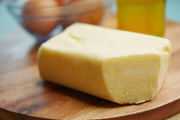 slice of a butter on a paper on table 