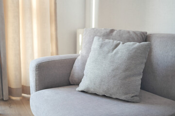 modern grey sofa with pillows in living room at home