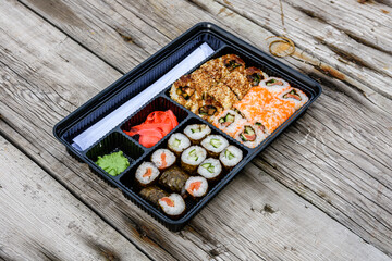 Set of the different sushi on wooden table