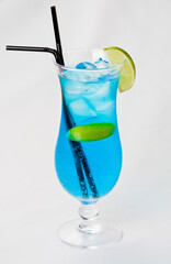 blue cocktail with lime isolated on white background