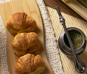 Argentinian breakfast. Croissants and yerba mate in still life. Cenital plane.