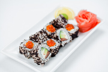Japanese sushi with salmon, Philadelphia cheese, avocado in white rice and flying fish roe with salmon caviar