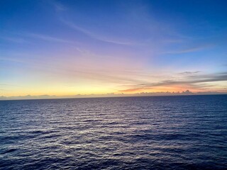 A gradient of blue and yellow in a sunset at sea