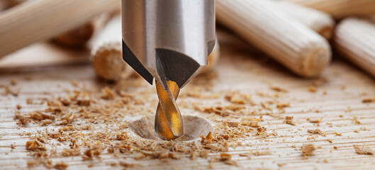 Countersink drill bit with steel triangle ruler make sink in hole for screw in wooden oak plank