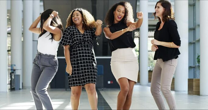 Wild, dancing and free women having fun, laughing and celebrating with music at work together. Carefree colleagues excited about good news, expressing joy with a victory dance of motion and energy