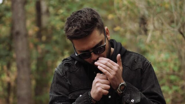 Stylish guy, man lights a cigarette. A hard day, a busy day, a crisis, bankruptcy, bad habits.