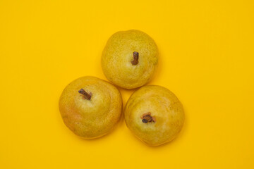Organic Pear on a yellow. Juicy fruit, cool minimal flat lay, copy space.