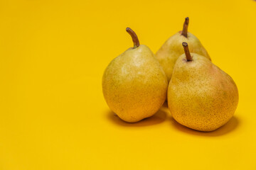 Organic Pear on a yellow. Juicy fruit, cool minimal copy space.