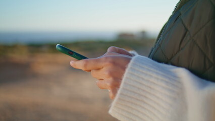 Closeup tourist hands messaging phone on weekend trip. Woman touching screen