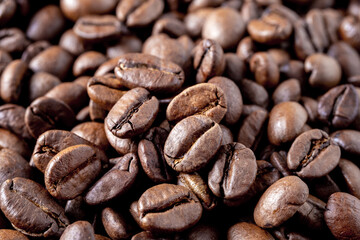 Close-up of roasted coffee beans as background. Selective focus.