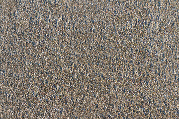 fine pebbles on a sandy tropical beach as a graphic background