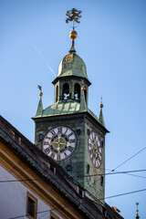 Fototapeta na wymiar Beautiful church tower with lion decoration and clock tower visible from the street in the city of Graz, Austria
