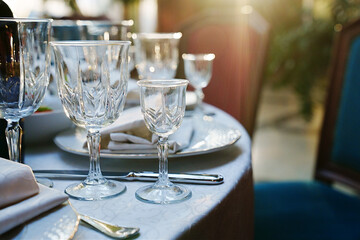 empty wine glasses on the table.table setting for a festive dinner. solar glare.