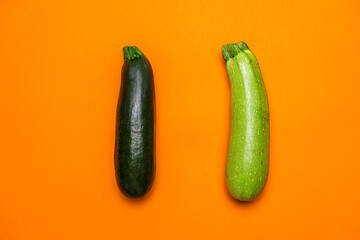 Organic green zucchini on orange background. Cool Minimal Flat Lay
