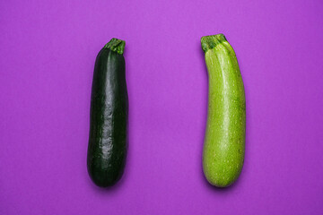 Organic green zucchini on purple background. Cool Minimal Flat Lay