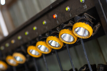 Shallow depth of field image of miners headlamps being charged while waiting for the next shift
