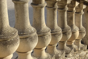 stone columns cascading downwards. Stone handrails (Nimes, France)