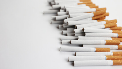Many cigarettes on a white background. A strong passion for smoking. Harmful to health. Smoking can be harmful to your health. It's a pity for the environment. Health problem, causes cancer. Cigarette